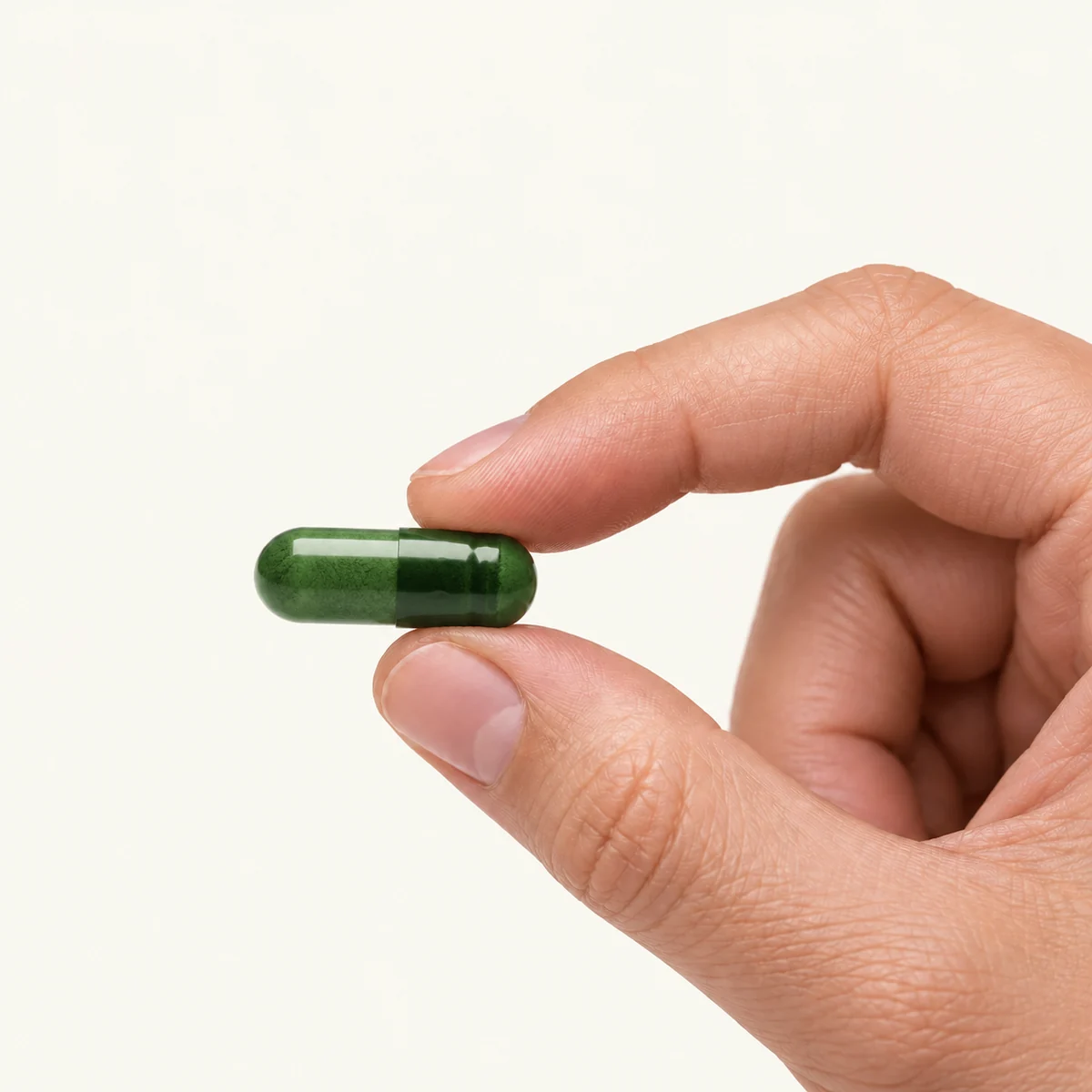Quatrefolic® Active Folate dosage form held between fingertips