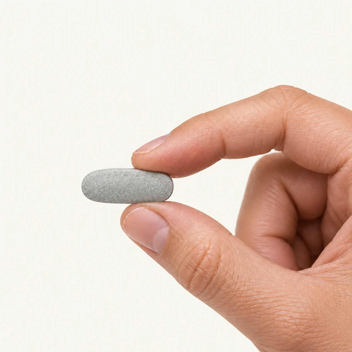 Multiminerals dosage form held between fingertips